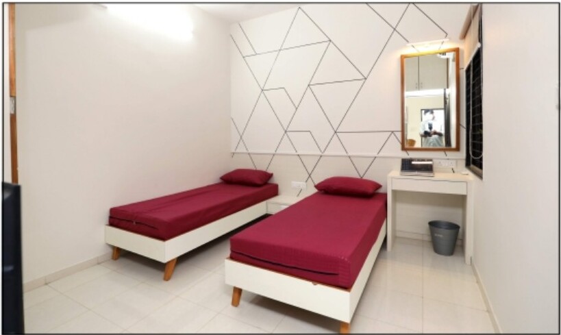 Furnished bedroom with cupboard at Positive Aura PG